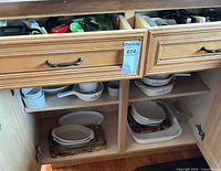 Cabinet with CorningWare, glass bowls, stoneware