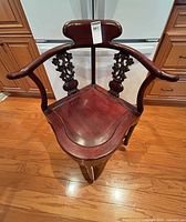 Full view hardwood corner armchair with curved arms and triangular seat