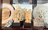 Shelf with resin Asian figurines, decorative plates, porcelain lady figurine, ceramic shoes