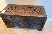 Front view of carved wooden chest showing overall design