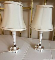 Front view of both matching porcelain table lamps with shades attached