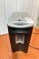 Front view of black and silver homeMAX shredder with clear bin window and power cord