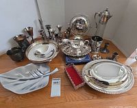 Group overview of all silver-plated and mixed metal items on floor