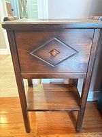 full view of table front showing drop-front compartment and lower shelf