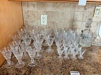 Full set of stemware and decanters displayed on countertop