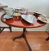 Overall view of table with assorted metal dishes and coasters displayed