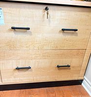 front view showing two drawers, handles, lock and keys