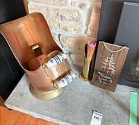 Overall lot showing ash bucket, match holder, plaque