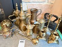 Group view of entire lot showing brass coffee pots, teapots, candlesticks and other items