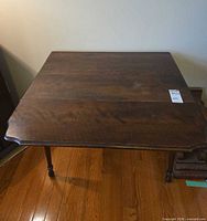Top view of table with both leaves down showing wood grain and surface wear