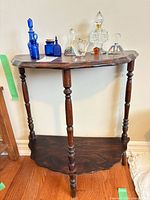 Full view of console table with perfume bottles displayed on top