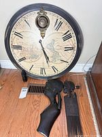 Round wall clock, two combs, small figurine displayed on floor