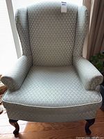 Front view of upholstered wingback chair