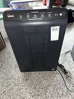 Front view of Winix 6300-2 air purifier showing control panel, intake grille and attached power cord