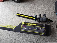 Hedge trimmer with original box on floor