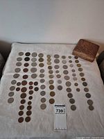 Full lot overview showing coins arranged on cloth and wooden box