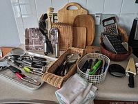 Overall lot view with utensils, boards, baskets, graters