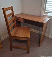Desk and chair together in corner showing overall appearance