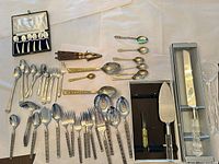 Group view of all flatware, boxed pieces, utensils and nutcracker