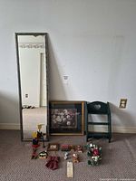 Overall view of mirror, shelf, framed print and assorted decor