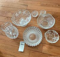 All seven clear glass items on floor with lot tag visible