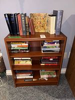 Full view of bookcase filled with assorted books
