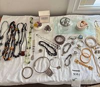 Group shot of all jewelry, perfume and trinket boxes on white cloth