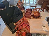 Group shot showing stand, bowls, crock with utensils, oven mitt, trivets, and textiles