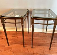 Pair of metal and glass end tables front view