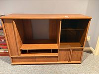 Front view of oak entertainment cabinet showing overall design