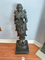 Full view of standing papier-mâché female figure on base