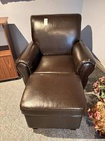 Front view of brown faux leather chair with ottoman