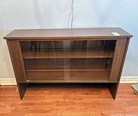 Front view showing entire sideboard, glass doors, finish