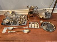Full lot overview showcasing all silver-plated pieces arranged on floor and tray