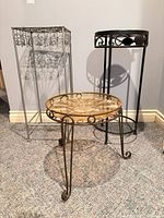 Front view of all three metal stands showing their form, sizes and finishes