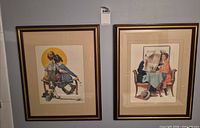 Both framed prints hung side by side on wall