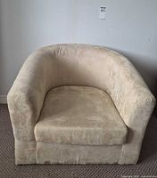 Front view of light beige suede-like upholstered club armchair