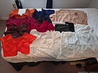 All garments and sandals laid out on bed