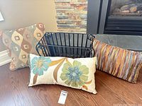 All three pillows and metal magazine rack grouped together