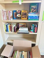 Overall view of shelves and open box showing quantity and variety of books