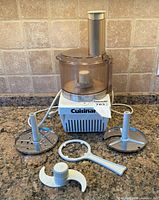 Overall view of Cuisinart food processor with accessories laid out