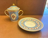 Cup with lid and saucer showing overall design