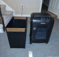 Shredder and wastebasket side by side