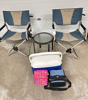 Full lot view showing two chairs, side table, chest cooler, soft cooler, pink coolers