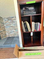 Full bookcase and box of books