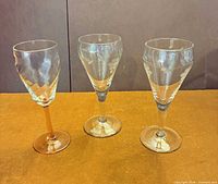 Three stemmed glasses side by side