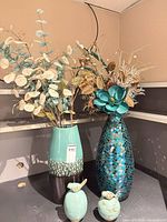 Two vases with bird figurines front view