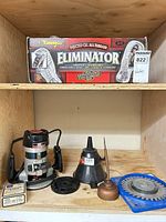 Overall lot on shelf showing router, dado blade, kneepads box, oil can, accessories