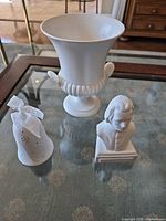 Group shot of vase, bust and bell ornament