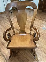 Front view showing seat, arms, pierced splat back